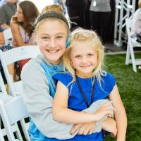 Two children sitting together at the Jamie Hosford Football Center dedication.